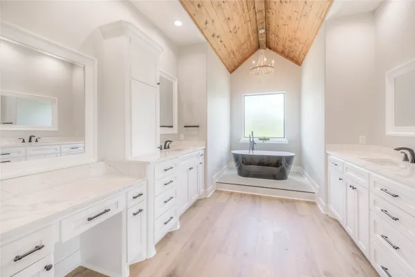 a spacious en suite bathroom with a double vanity sink and a mirror
