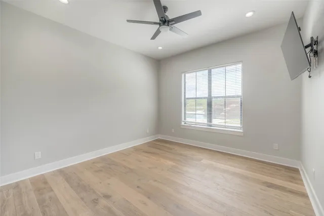 wooden floor in an empty room with a window