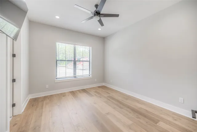 wooden floor in an empty room with a window