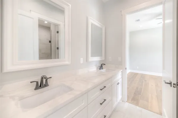 a bathroom with a sink vanity and a mirror