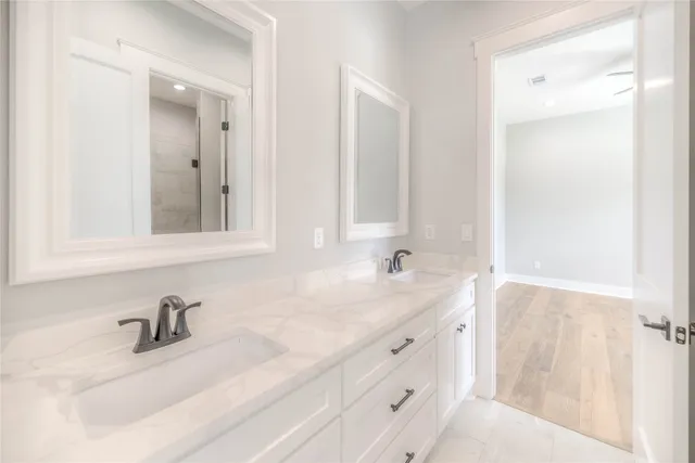 a bathroom with a sink vanity and a mirror