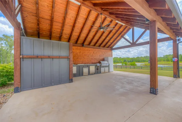 a view of a porch with wooden floor and roof