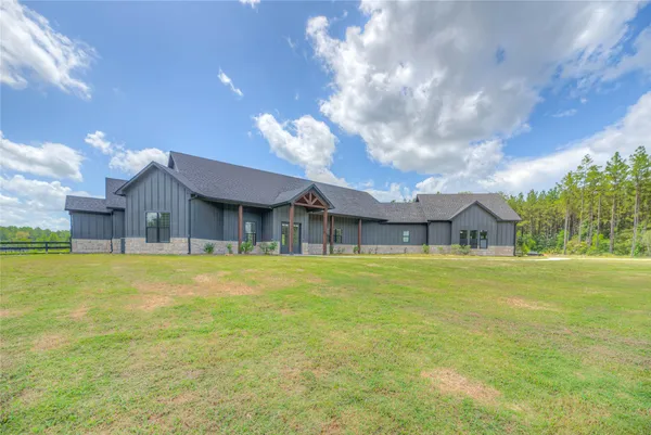 a house view with swimming pool in front of it