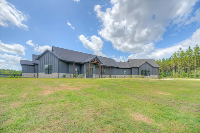 a house view with swimming pool in front of it