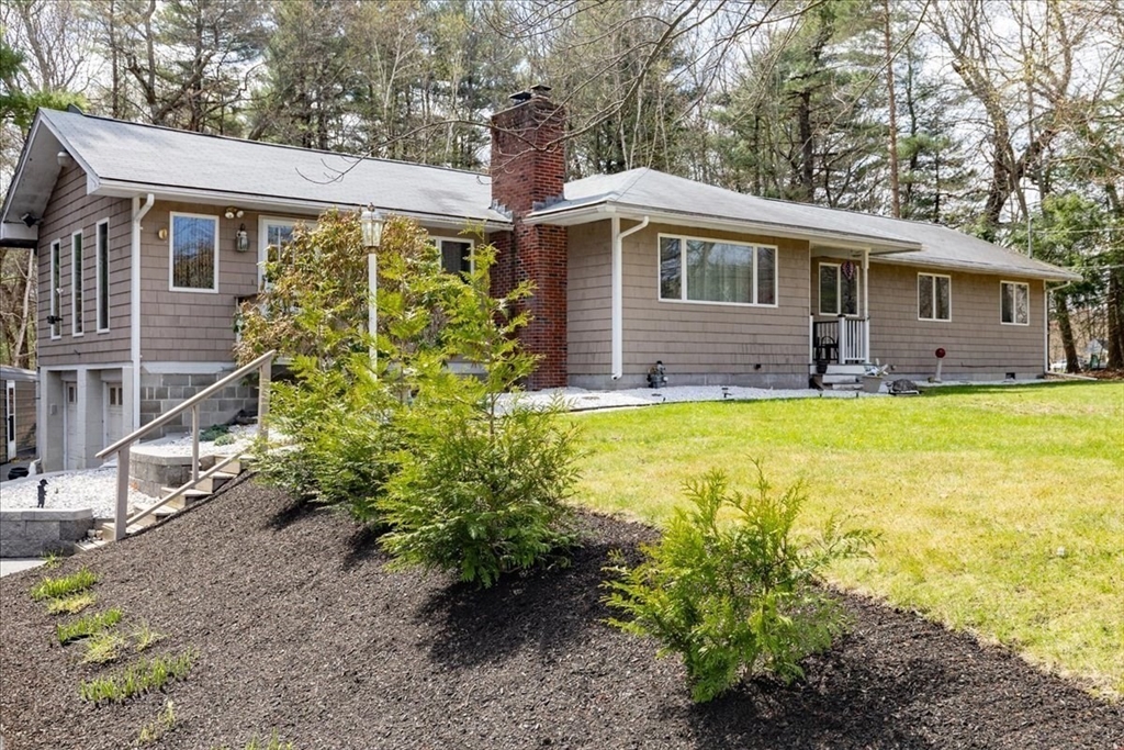 1083 Broadway Road Dracut, MA 01826 - Photo 1 of 28 a front view of a house with garden