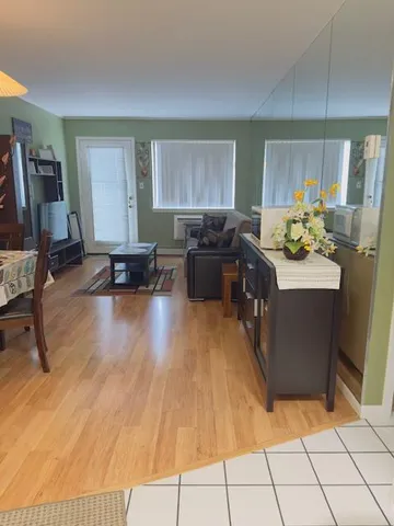 a kitchen with a sink and living room view
