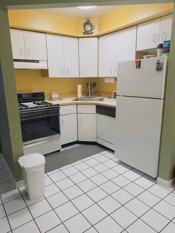 a kitchen with a sink cabinets and appliances