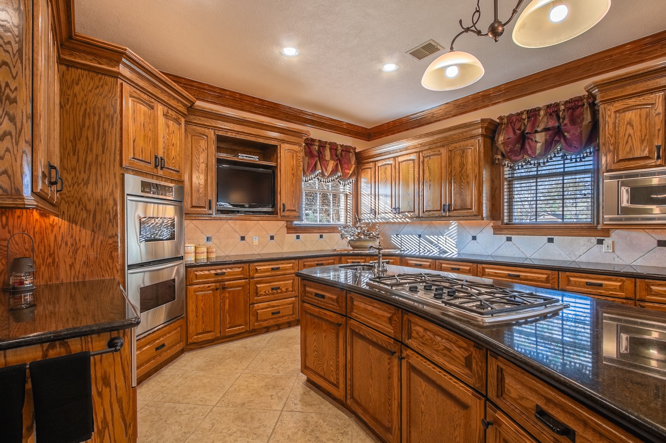 3150 Holmes Road Richmond, TX 77406 - Photo 17 of 28 a kitchen with stainless steel appliances granite countertop a stove and a sink