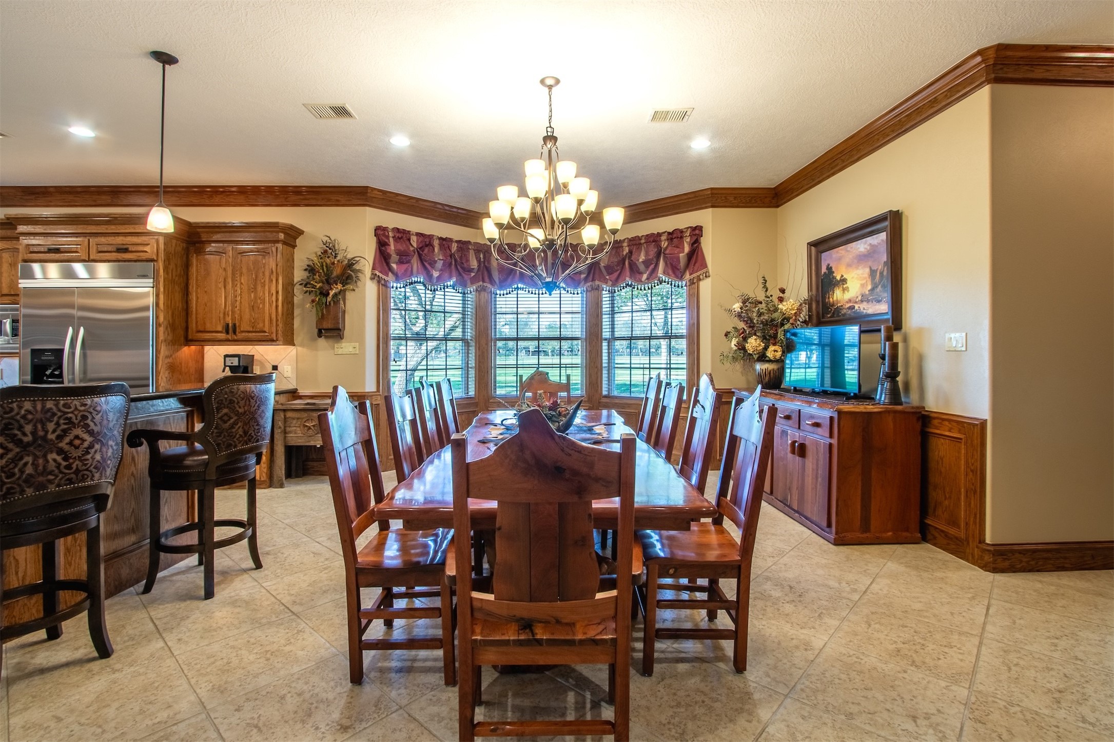 3150 Holmes Road Richmond, TX 77406 - Photo 18 of 28 a view of a dining room with furniture a chandelier and large windows
