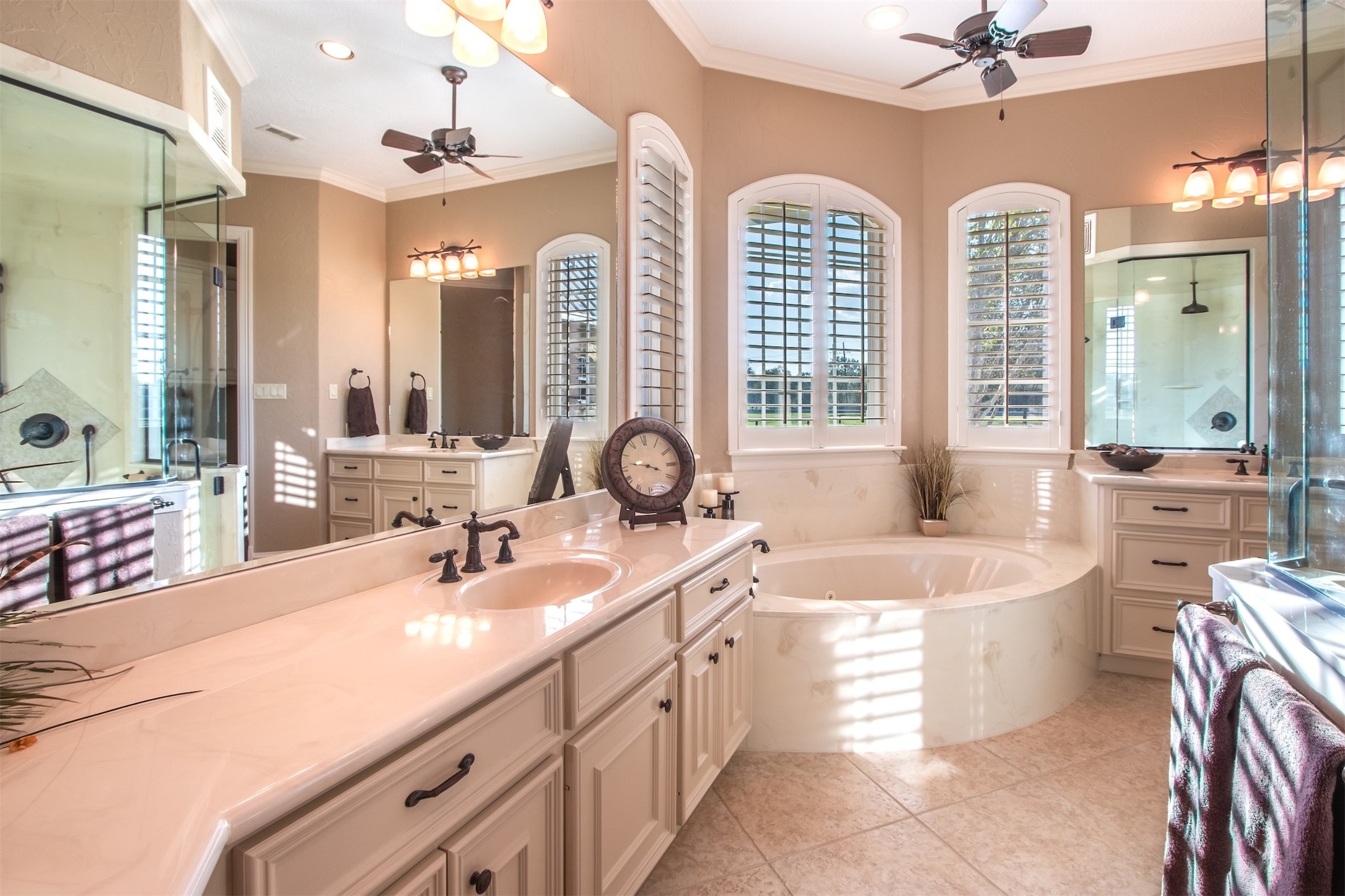 3150 Holmes Road Richmond, TX 77406 - Photo 20 of 28 a large bathroom with a double vanity sink a mirror a bathtub and next to a window