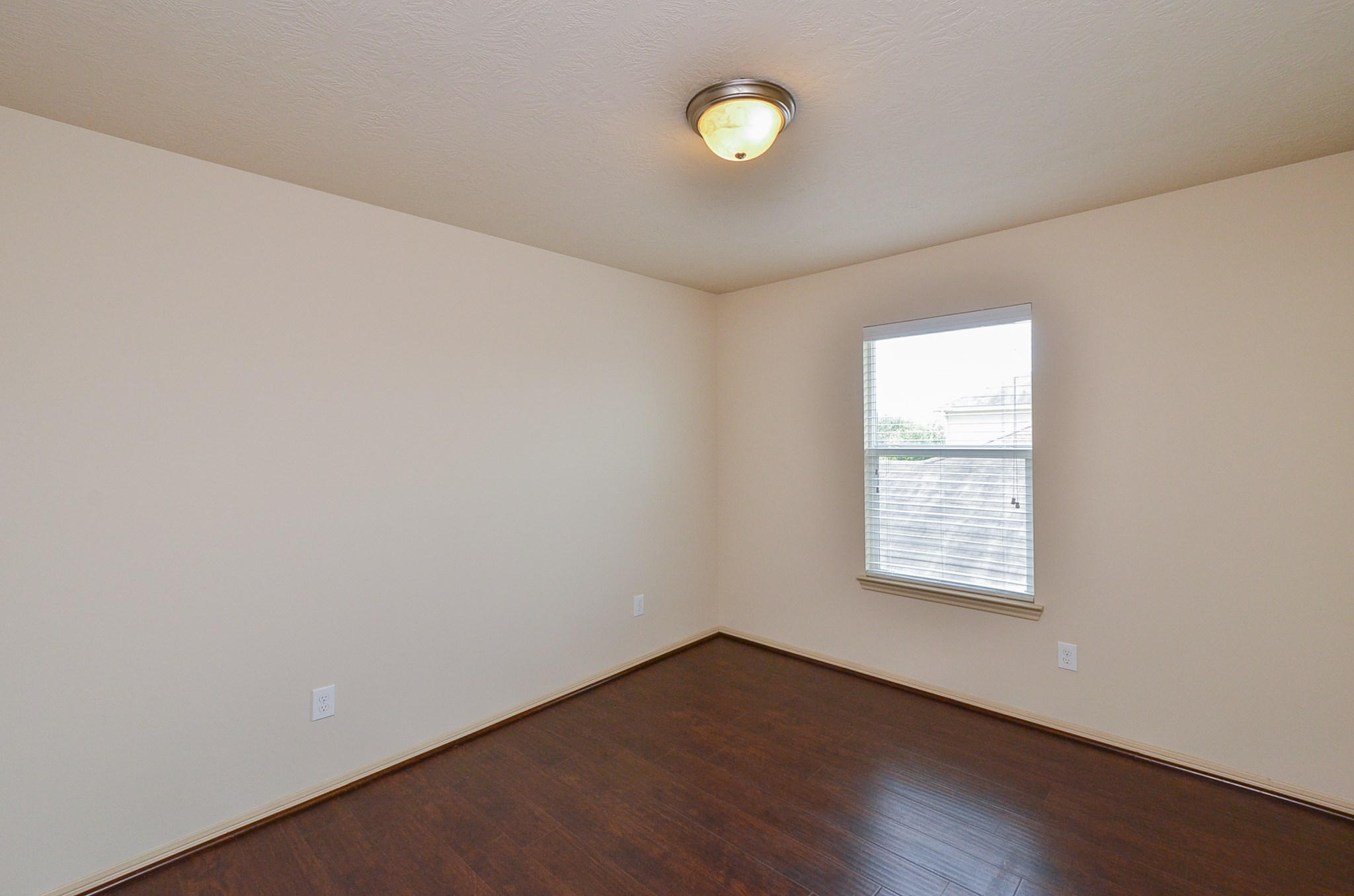 25135 Ginger Ranch Drive Katy, TX 77494 - Photo 26 of 32 Guest bedroom 2: Natural light from the window brightens this comfortable bedroom, complemented by wood-style flooring throughout.