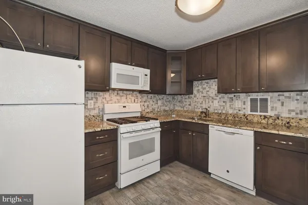 a kitchen with a sink a stove and refrigerator
