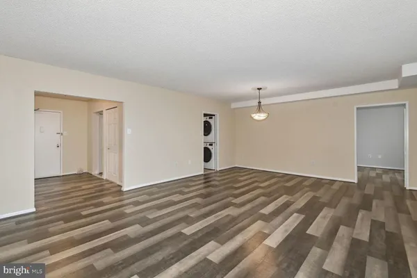 a view of a livingroom with wooden floor and white walls