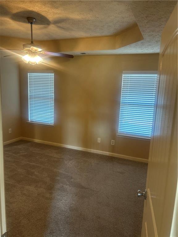 22 Pawnee Trail Fort Mitchell, AL 36856 - Photo 17 of 40 Recessed ceiling with integrated lighting, ceiling fan, and two windows with blinds