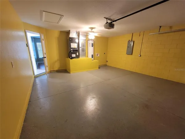 a view of a big room with wooden floor and windows
