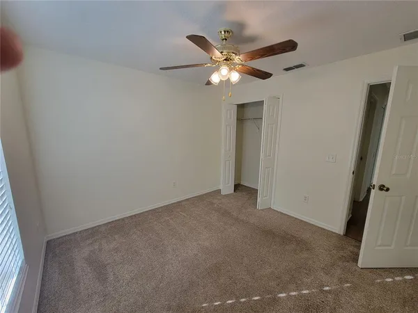a view of an empty room and wooden floor