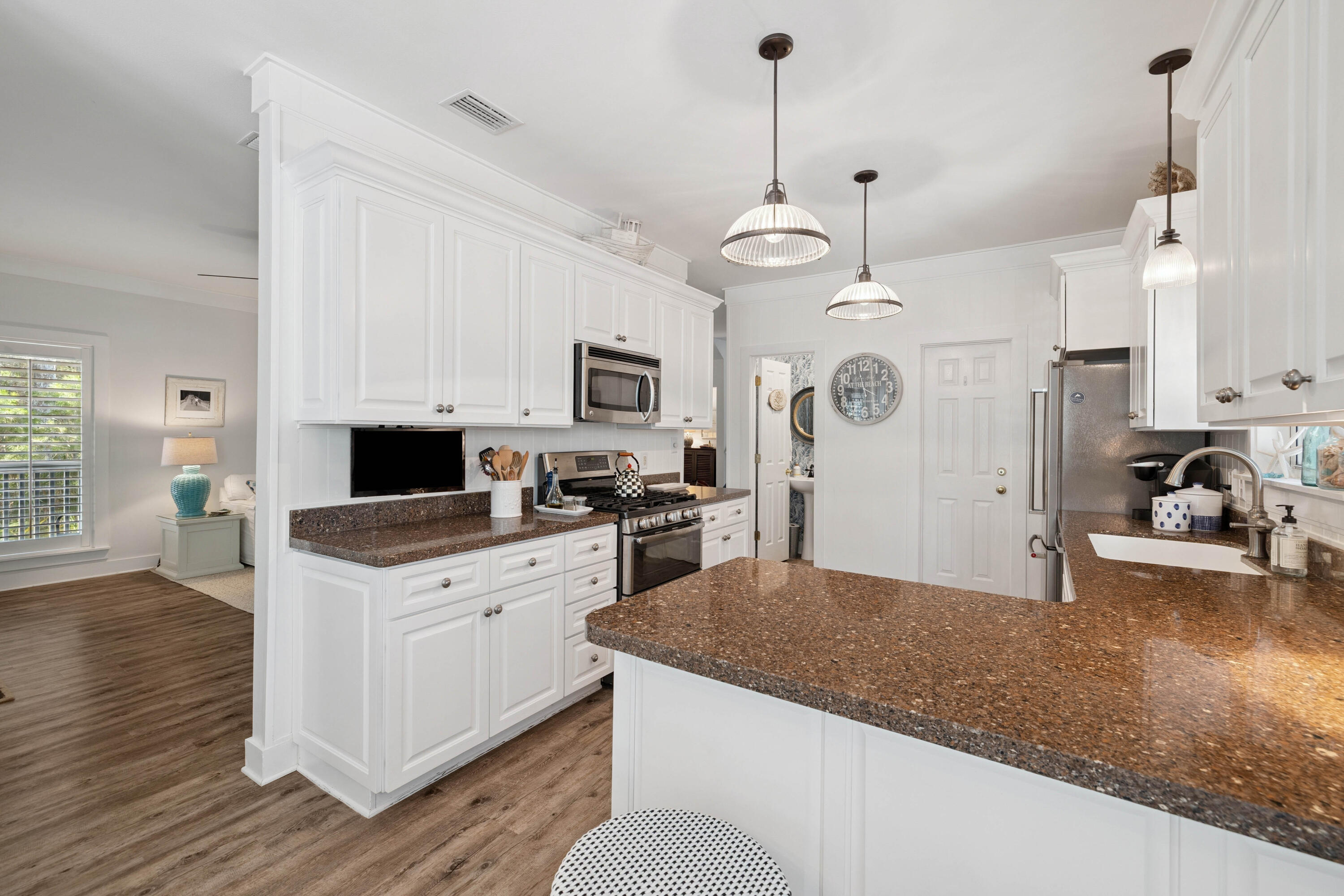 298 Cullman Avenue Santa Rosa Beach, FL 32459 - Photo 14 of 63 a kitchen with stainless steel appliances kitchen island granite countertop a stove a sink dishwasher a refrigerator and a fireplace with wooden floor