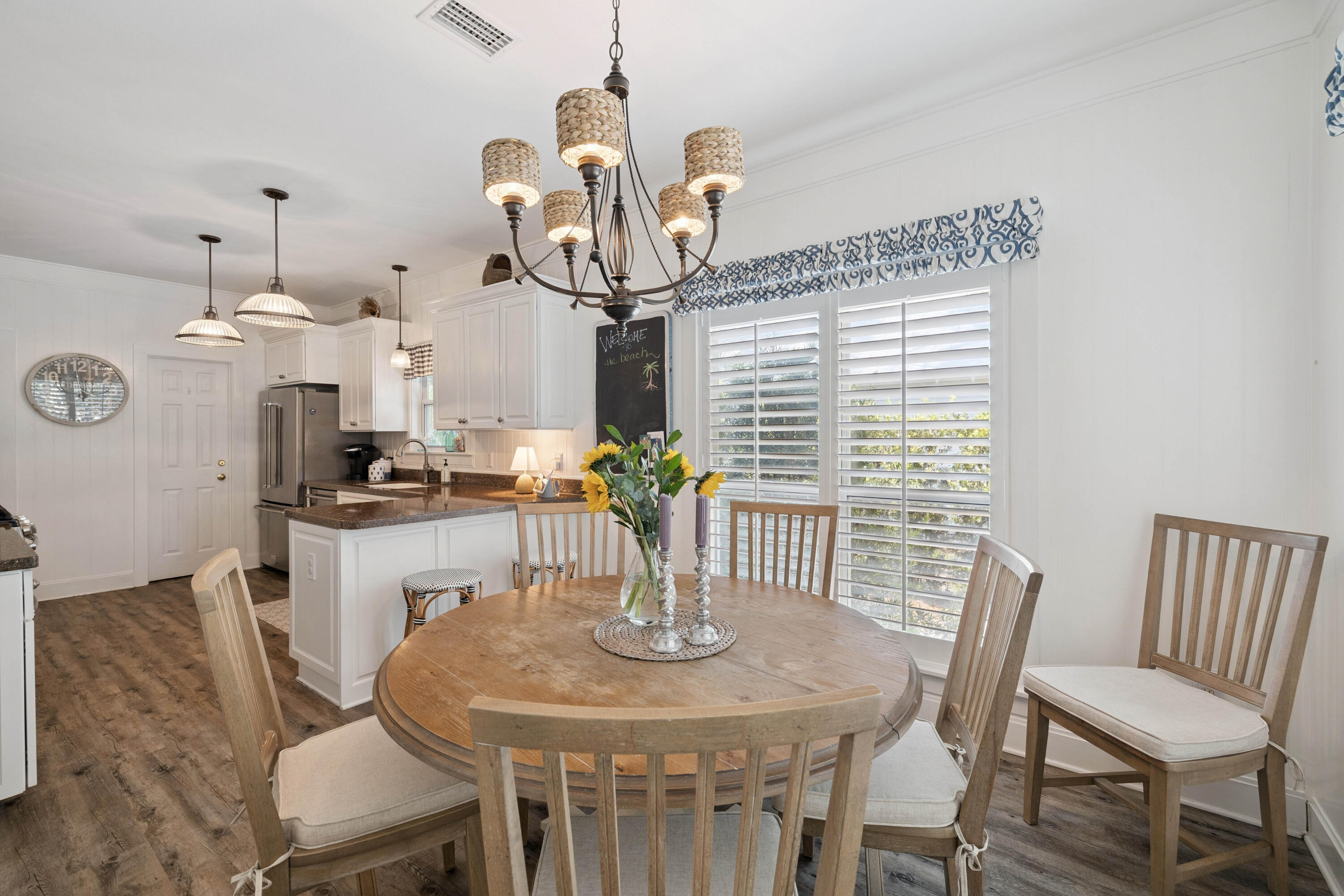 298 Cullman Avenue Santa Rosa Beach, FL 32459 - Photo 16 of 63 a view of a dining room with furniture a chandelier windows and wooden floor