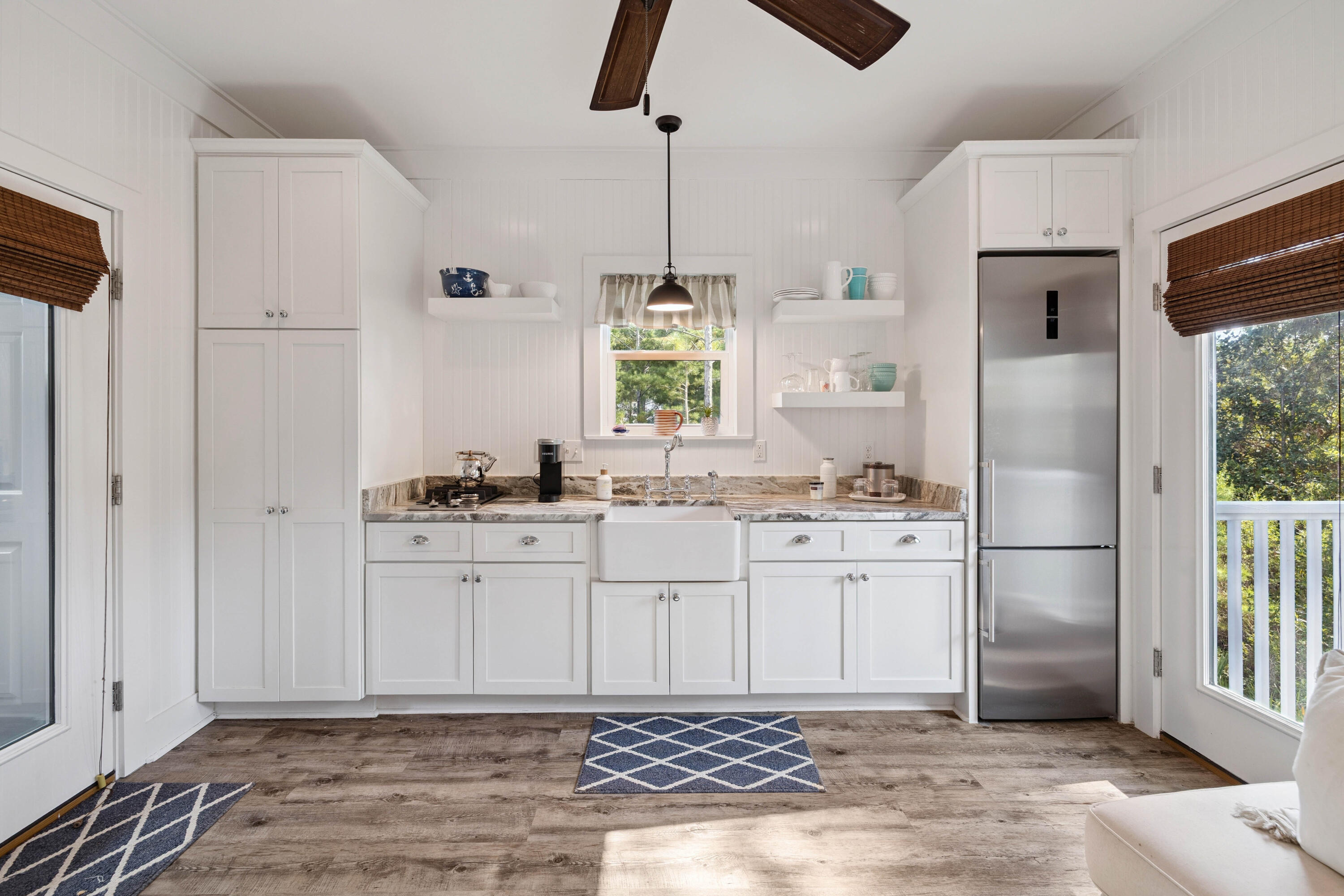 298 Cullman Avenue Santa Rosa Beach, FL 32459 - Photo 48 of 63 a kitchen with stainless steel appliances granite countertop a refrigerator a sink and white cabinets
