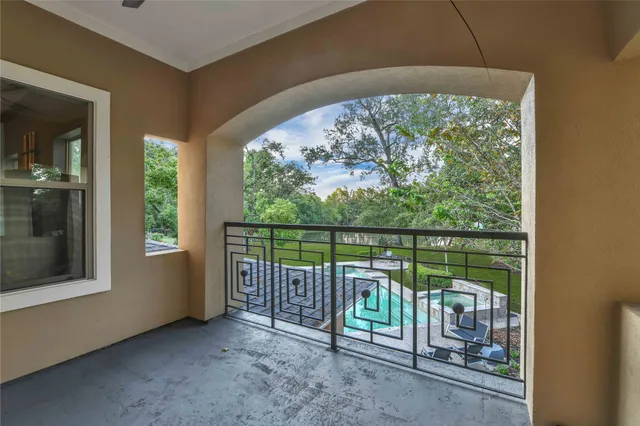 a room with furniture pool table flat screen tv and a chandelier