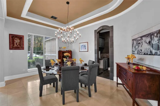 a view of a dining room with furniture and chandelier