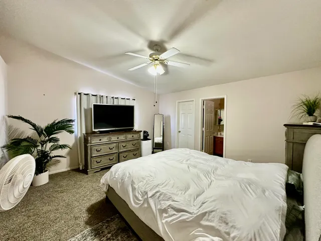 a bedroom with a bed and a flat screen tv