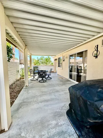 a living room with furniture and large windows