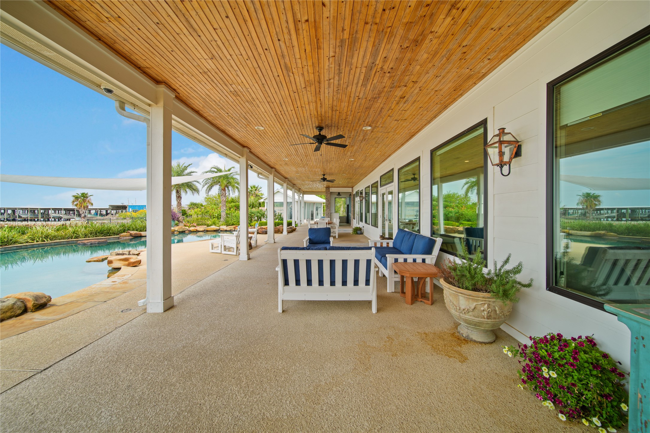 206 Avenue A Dickinson, TX 77539 - Photo 26 of 38 Covered Patio the entire length of the Home! Added Lighting, Fans, Mosquito Mist, & Outdoor Speakers
