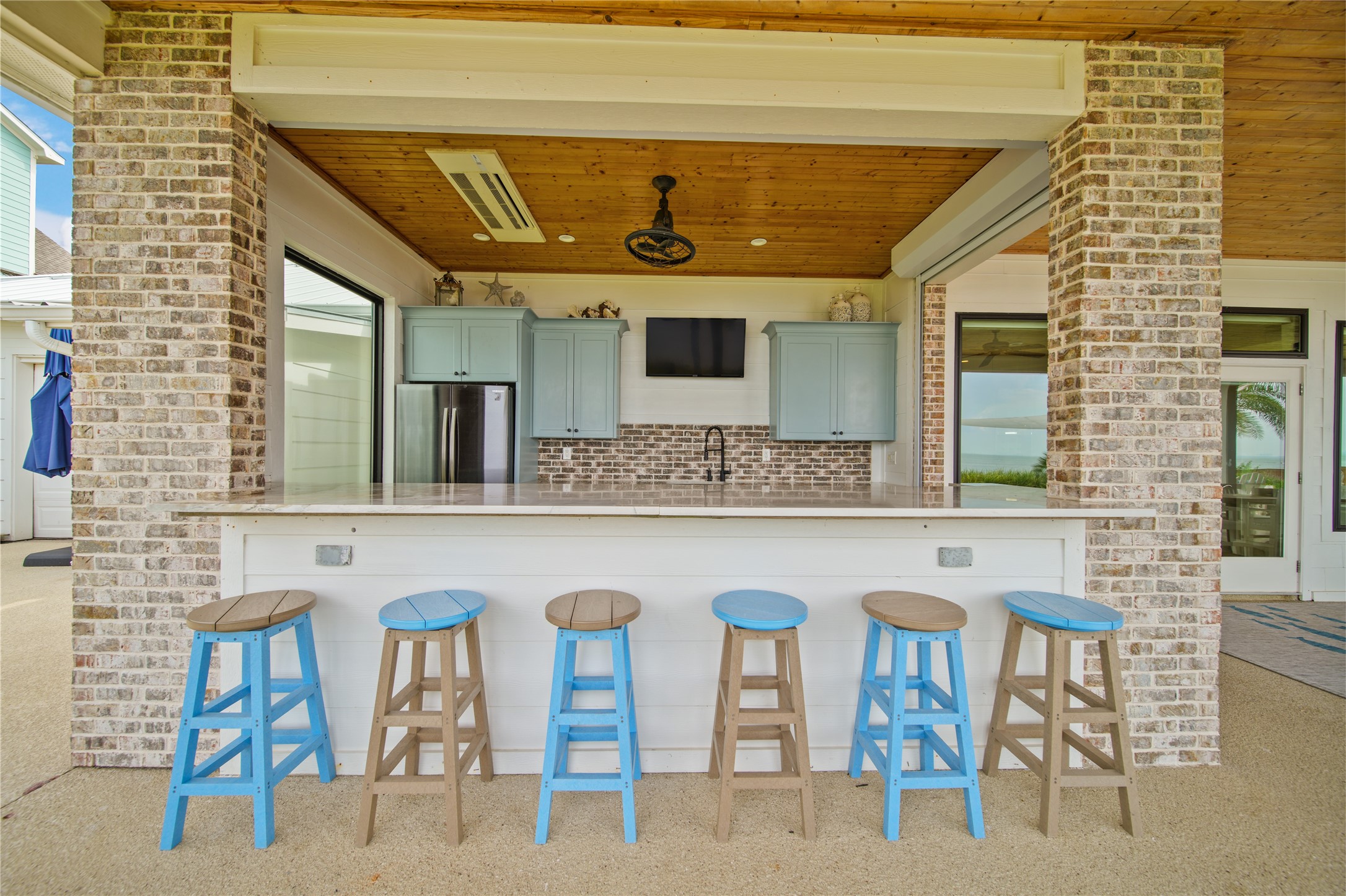 206 Avenue A Dickinson, TX 77539 - Photo 27 of 38 Easy Entertaining! Updated Outdoor Kitchen with Full Size Fridge, Dishwasher, Sink (with disposal) Ice Maker, Custom Cabinets and plenty of storage space.