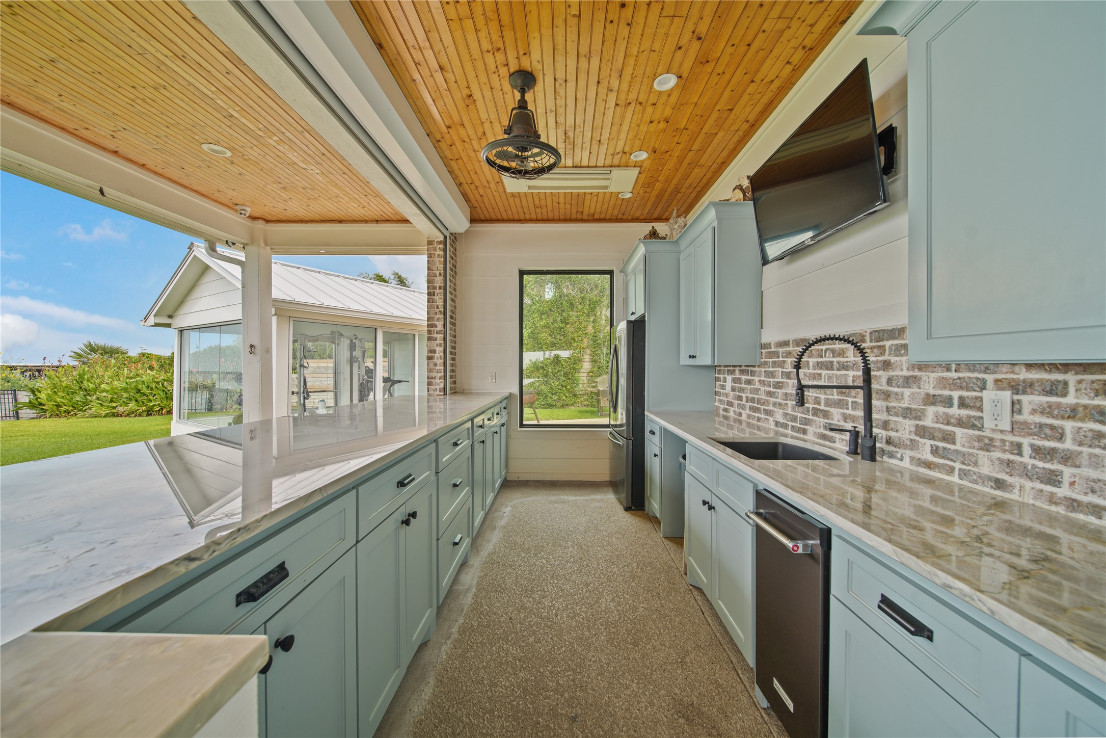 206 Avenue A Dickinson, TX 77539 - Photo 28 of 38 Another View of the outdoor kitchen, Plenty of Lighting, Quartz Counter Tops and a TV for Game Watching and Fun!