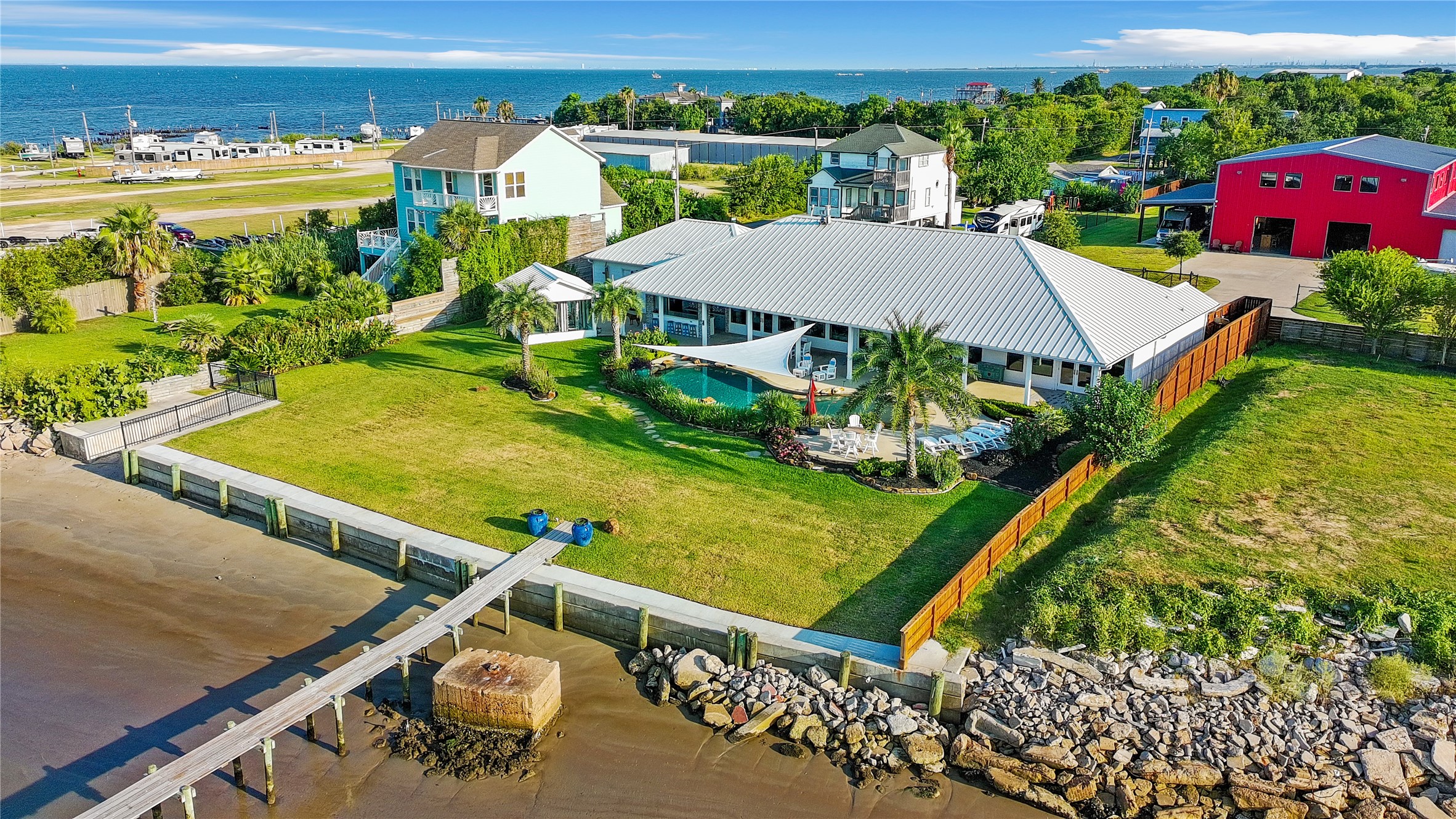 206 Avenue A Dickinson, TX 77539 - Photo 32 of 38 Breathtaking View of the home, Pool/Spa and Tropical Landscaping