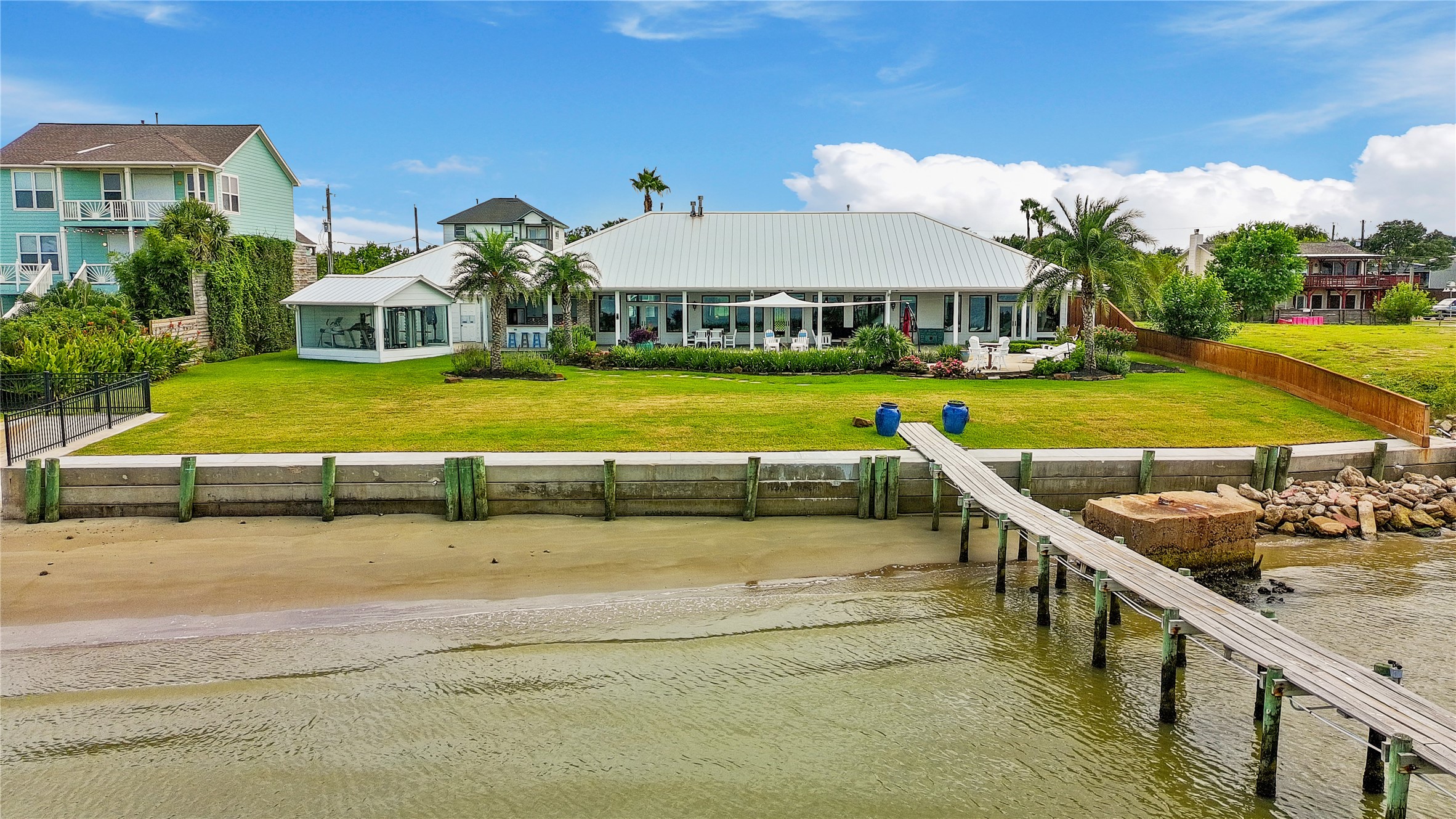 206 Avenue A Dickinson, TX 77539 - Photo 34 of 38 Great View of the Home, Gym and Pier. You can also see the sandy beach entry to the Bay