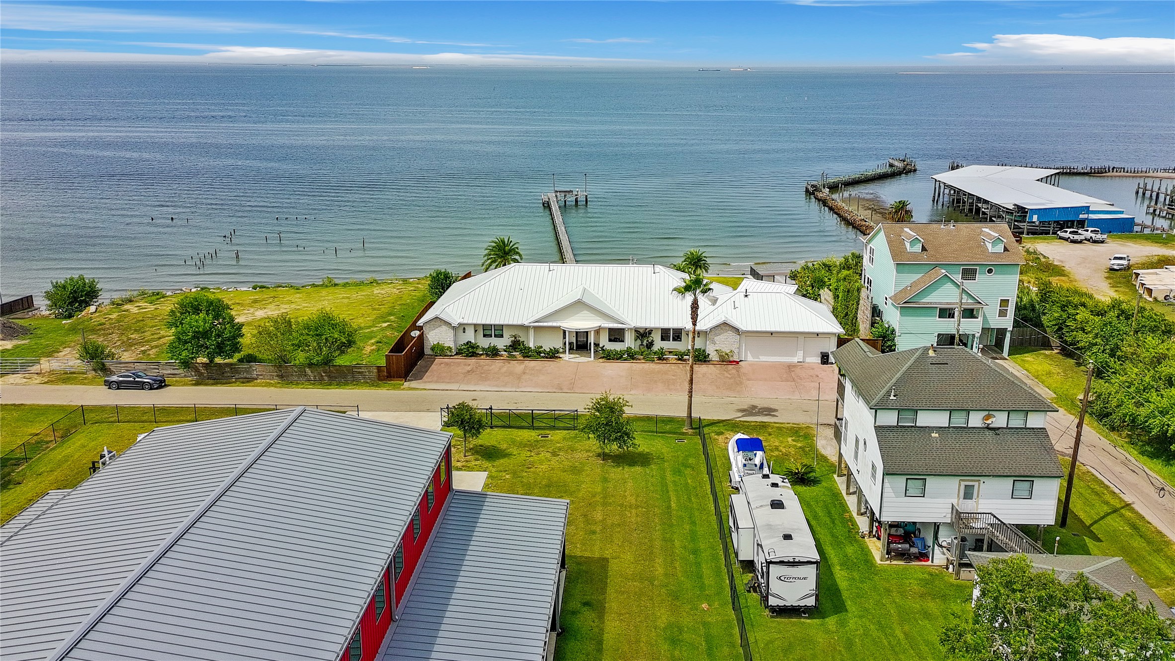 206 Avenue A Dickinson, TX 77539 - Photo 36 of 38 View of the Home and Galveston Bay from the Party Barn.