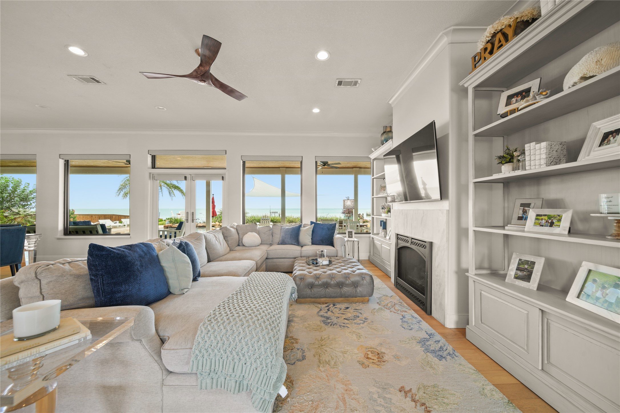 206 Avenue A Dickinson, TX 77539 - Photo 5 of 38 Beautiful Family Room, Gas Fireplace, Recent Wood Flooring, Electric Shades with an Amazing View of the backyard and Galveston Bay!