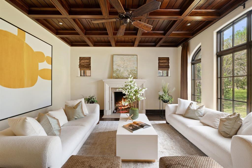 4120 Cochran Chapel Road Dallas, TX 75220 - Photo 4 of 40 a living room with furniture a fireplace and a chandelier