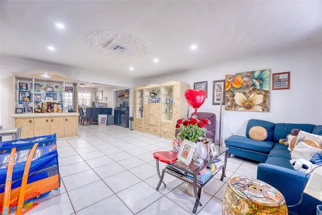 a living room with furniture and a bookshelf