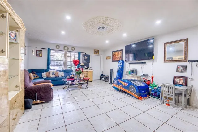 a kitchen with a refrigerator and a stove top oven