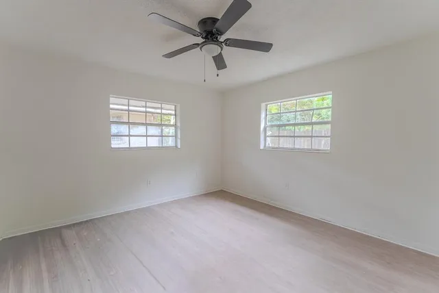 a bathroom with a granite countertop sink mirror vanity and toilet