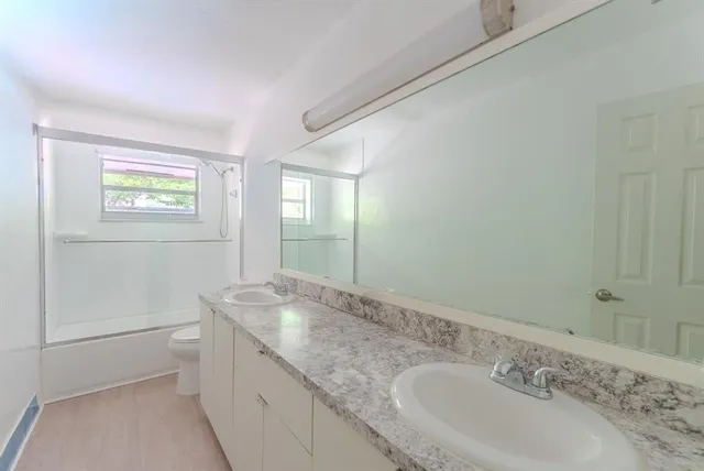 a kitchen with a refrigerator sink and cabinets