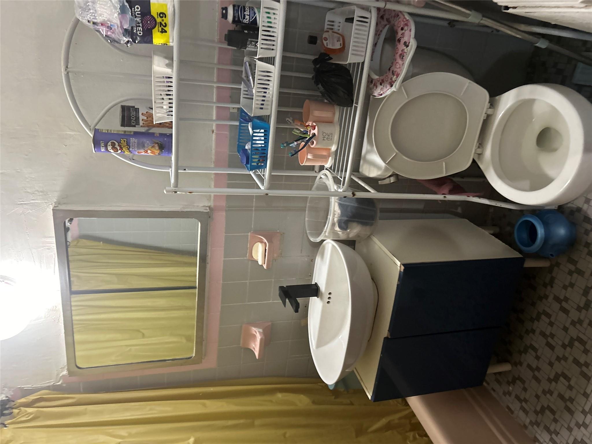 1210 White Plains Road Bronx, NY 10472 - Photo 2 of 5 Full bathroom with shower / bathtub combination with curtain, tile walls, backsplash, vanity, and toilet