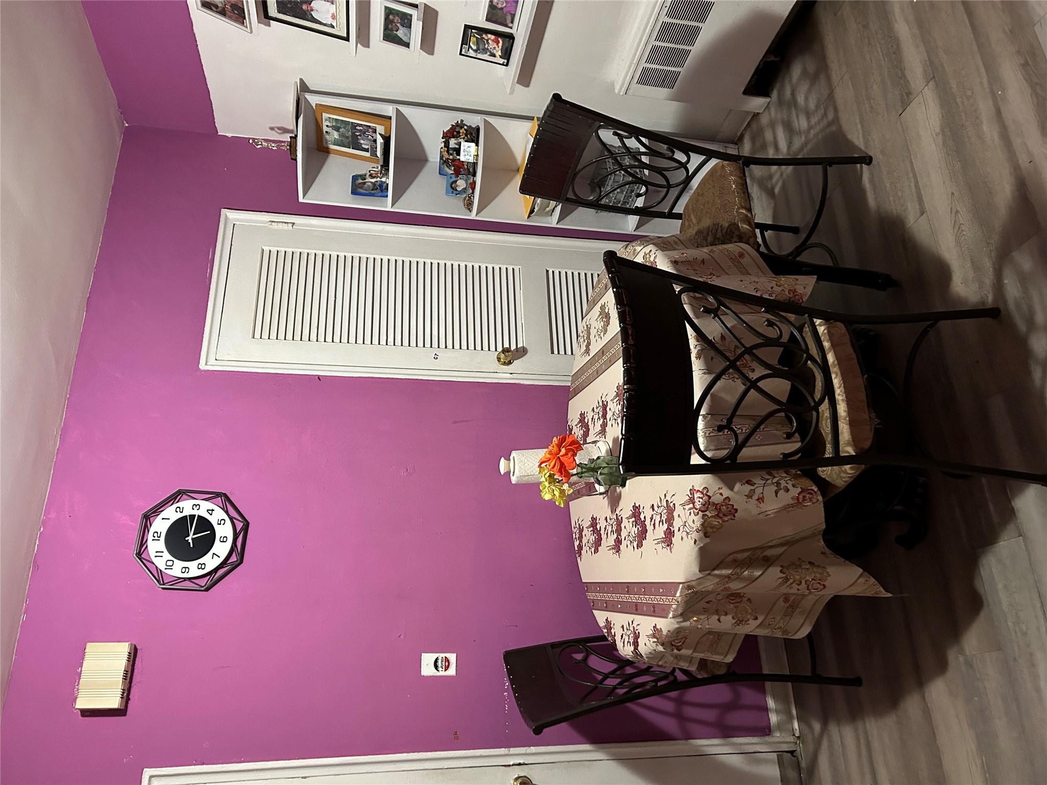 1210 White Plains Road Bronx, NY 10472 - Photo 3 of 5 Dining room with wood-type flooring and radiator heating unit