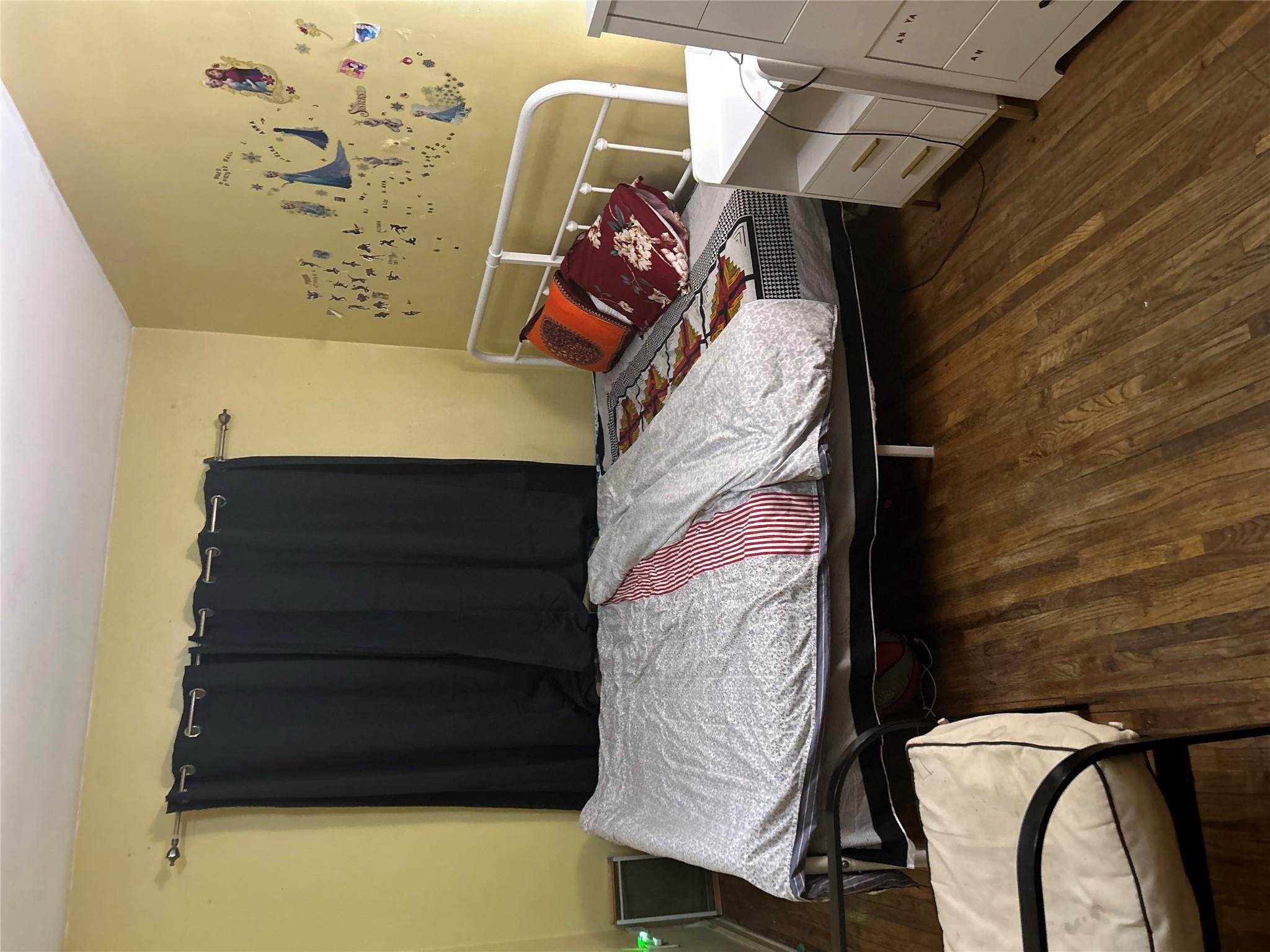 1210 White Plains Road Bronx, NY 10472 - Photo 5 of 5 Bedroom featuring dark hardwood / wood-style flooring