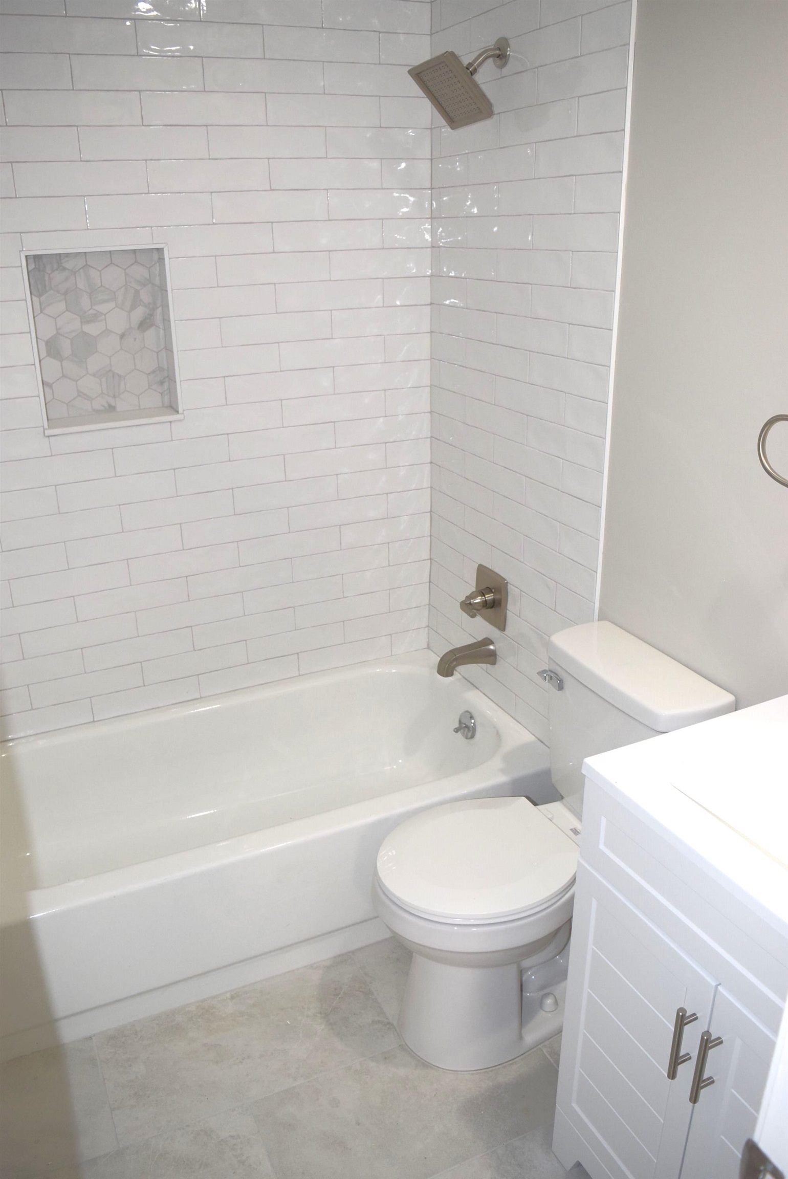 1831 Allenby Green, Unit 1831 Germantown, TN 38139 - Photo 17 of 25 a white toilet and tub sitting next to a bathroom sink