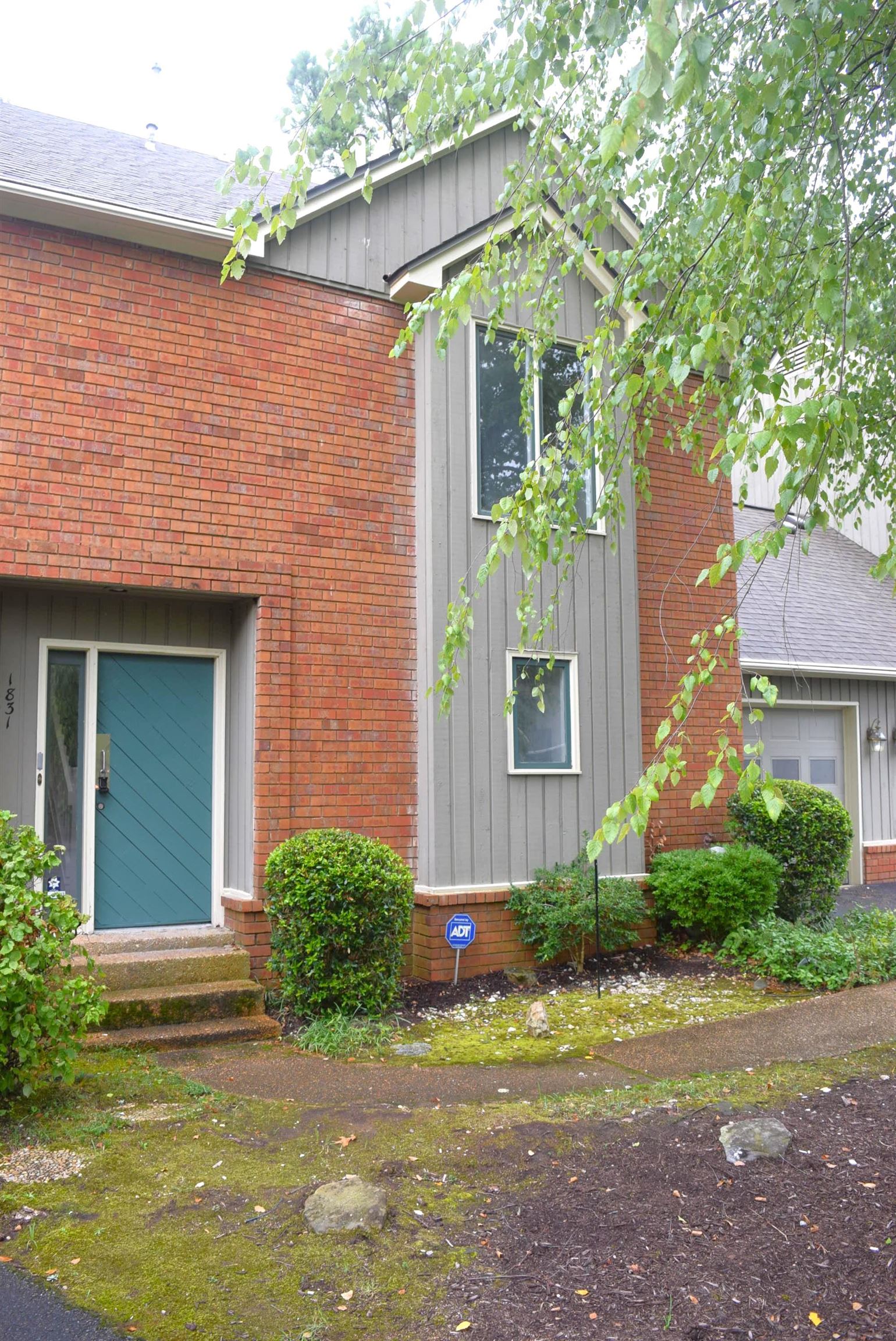 1831 Allenby Green, Unit 1831 Germantown, TN 38139 - Photo 2 of 25 a view of a house with brick walls plants and large tree