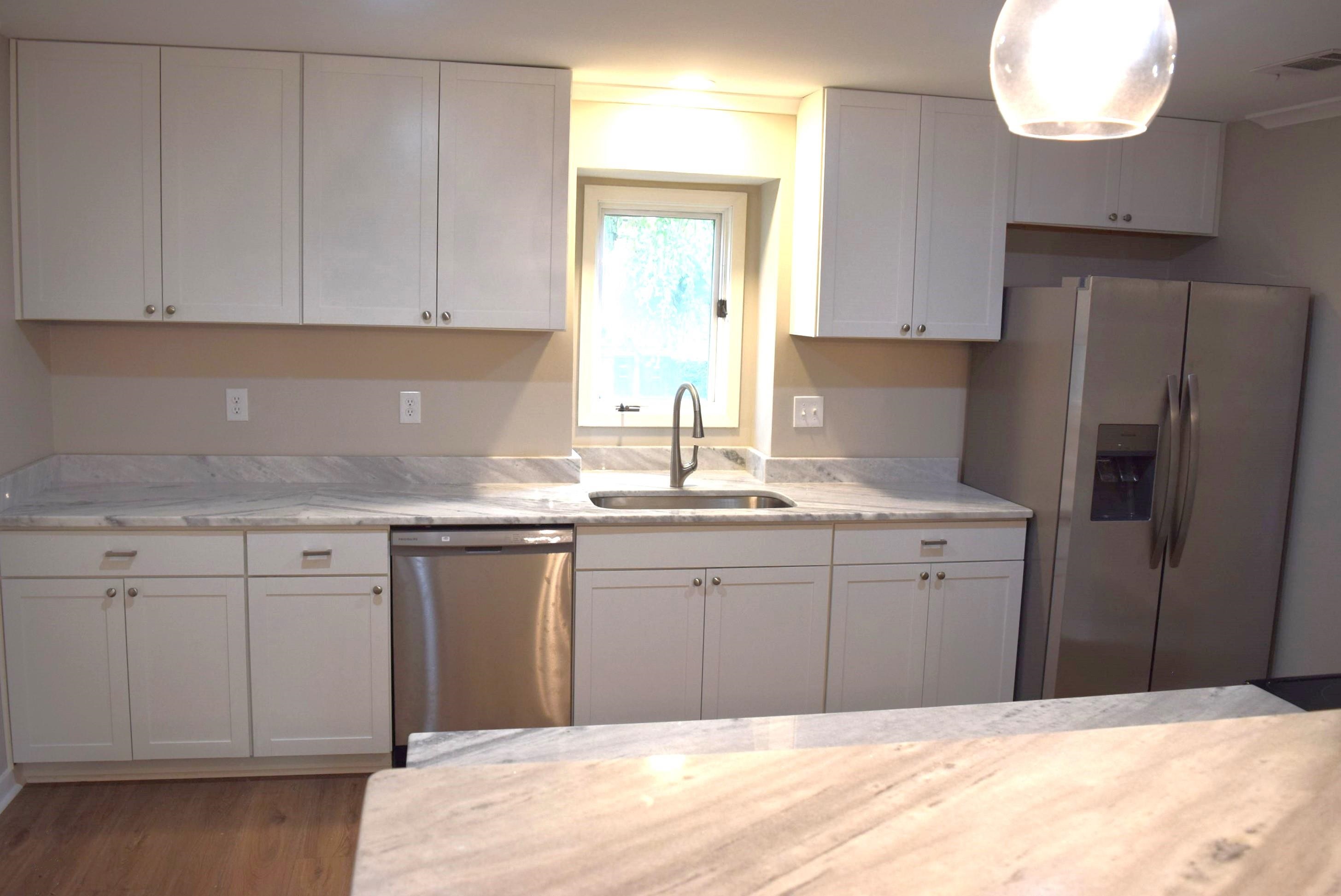 1831 Allenby Green, Unit 1831 Germantown, TN 38139 - Photo 4 of 25 a kitchen with granite countertop a sink cabinets stainless steel appliances and a window