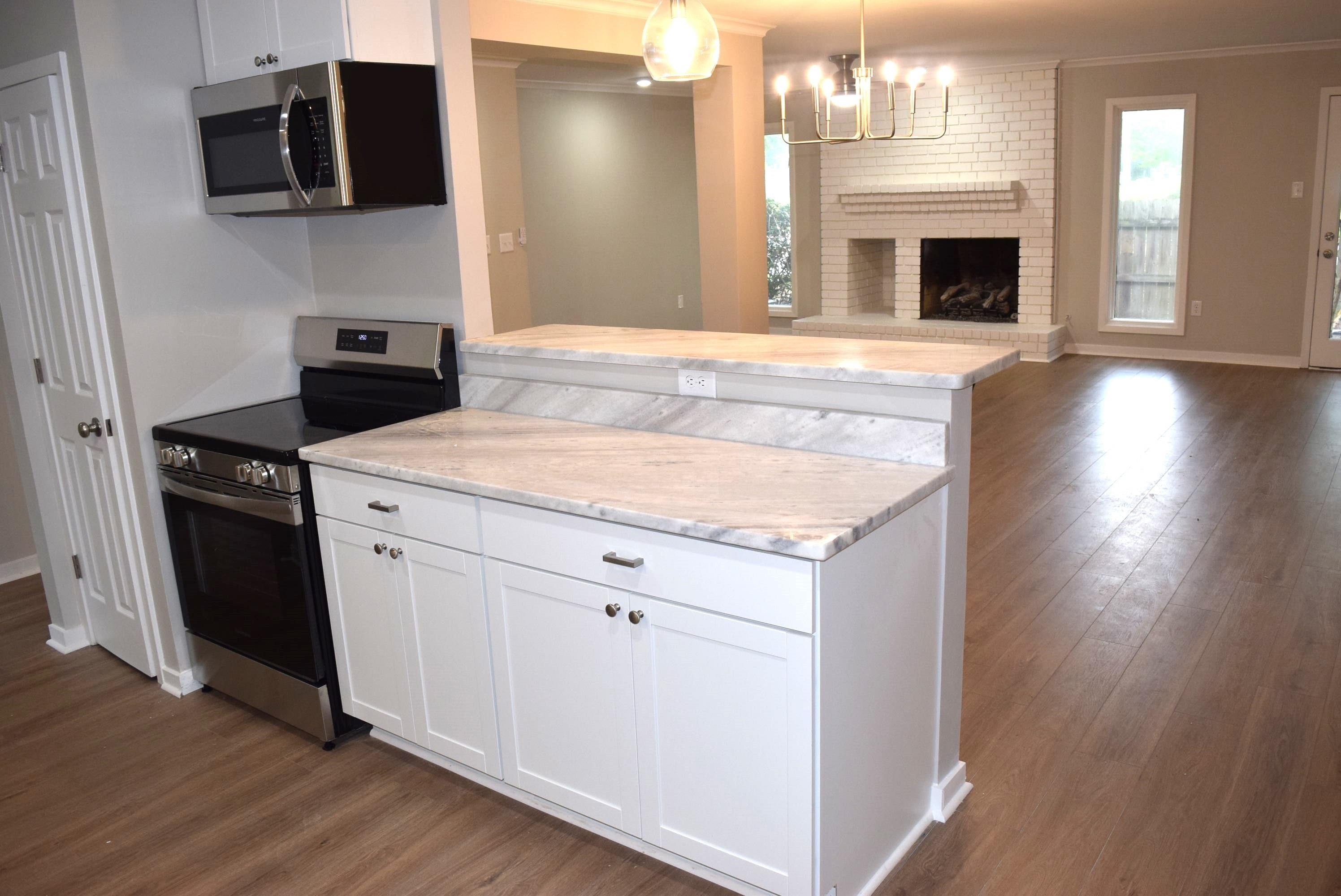 1831 Allenby Green, Unit 1831 Germantown, TN 38139 - Photo 24 of 25 a kitchen with a stove and a wooden floor