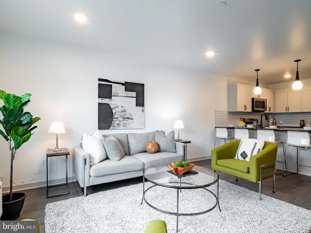 a living room with furniture and kitchen view