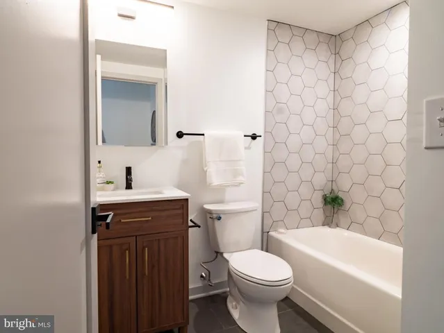 a bathroom with a sink a toilet and a bathtub