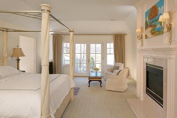 195 Newton Street Brookline, MA 02467 - Photo 13 of 16 a spacious bedroom with a bed and a fireplace