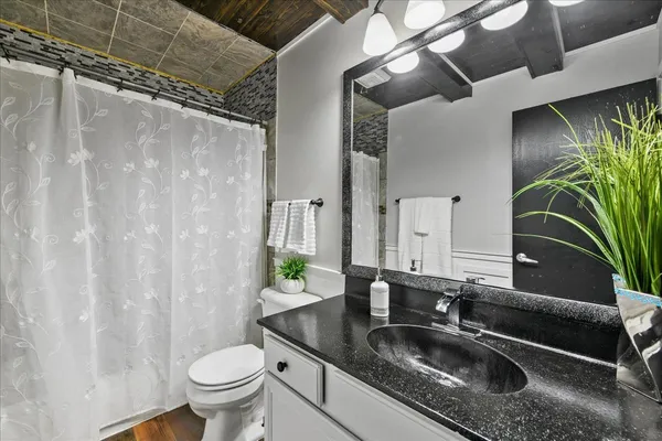 a kitchen with stainless steel appliances kitchen island granite countertop a refrigerator and a stove top oven